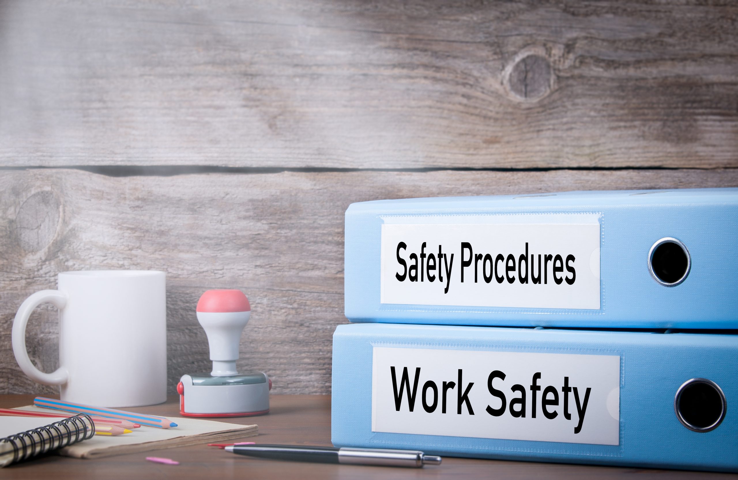 Work Safety and Safety Procedures. Two binders on desk in the office. Business background.